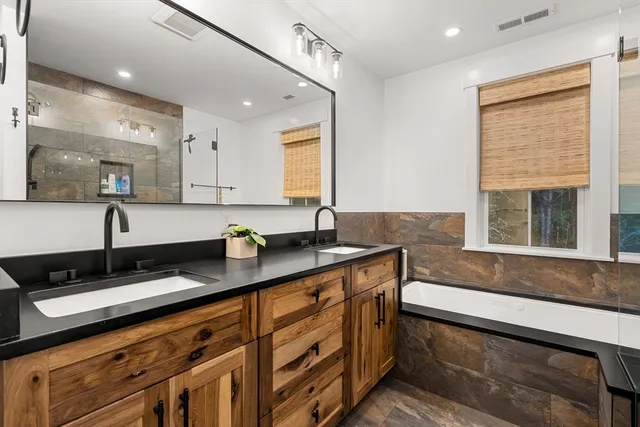 a kitchen with granite countertop a sink and a white wooden cabinets