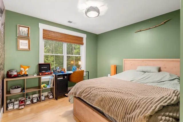 a bedroom with a bed and a desk