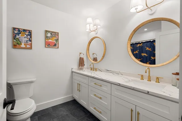 a bathroom with a toilet a sink and a mirror