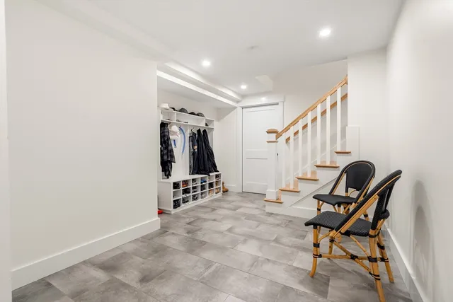 a view of a room with chairs and stairs
