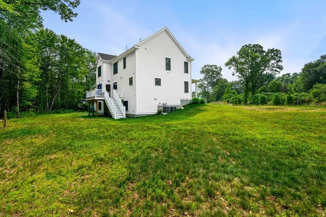 a view of a backyard with white house