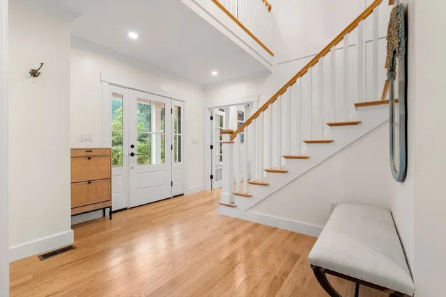 a view of entryway and hall with wooden floor