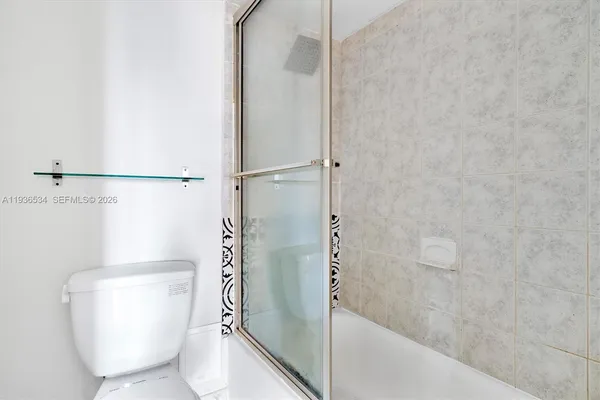 a bathroom with a shower and toilet