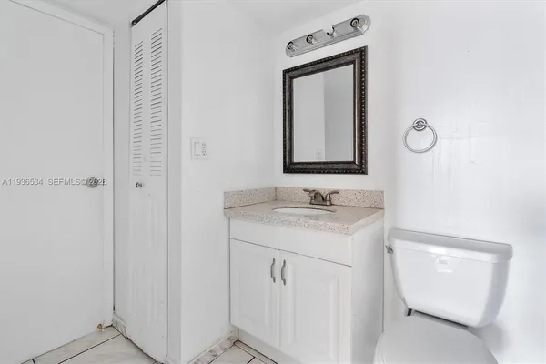 a bathroom with a sink a toilet and mirror