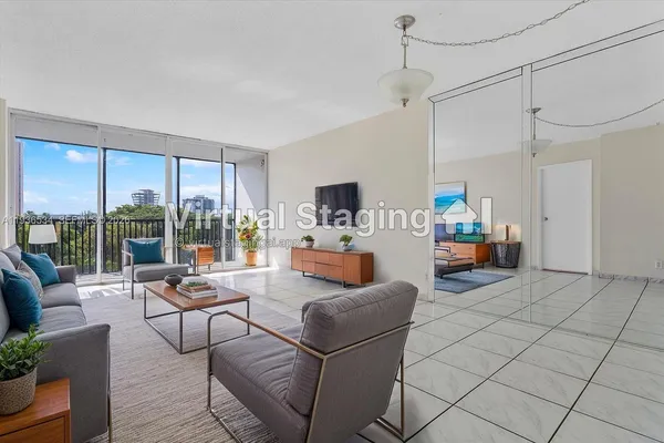 a living room with patio furniture and a flat screen tv