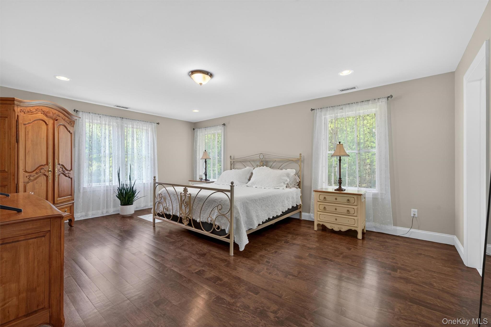 28 Bethlehem Road New Windsor, NY 12553 - Photo 30 of 50 a bed sitting in a spacious bedroom next to a window and wooden floor