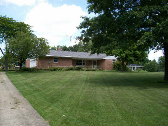 5685 Tipple Road Rockford, IL 61102 - Photo 2 of 4 a front view of a house with a garden