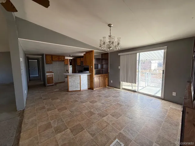 a view of a kitchen with a sink and a refrigerator