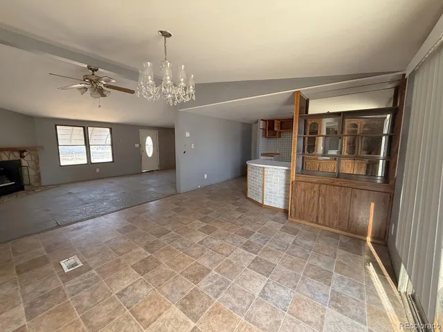 a view of a big room with windows and chandelier