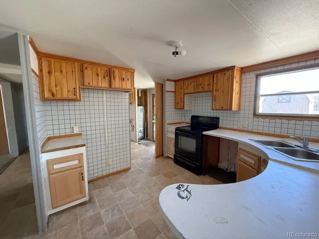 a kitchen that has a sink and a stove