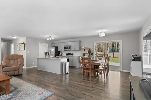 a view of a dining room with furniture and wooden floor