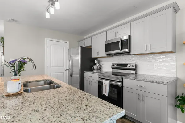 a kitchen with a sink stove and microwave