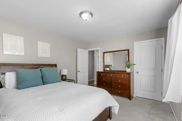 a bedroom with a bed and a dresser