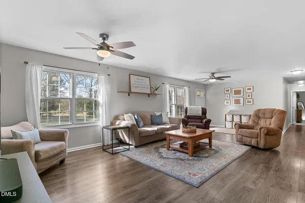 a living room with furniture rug and window