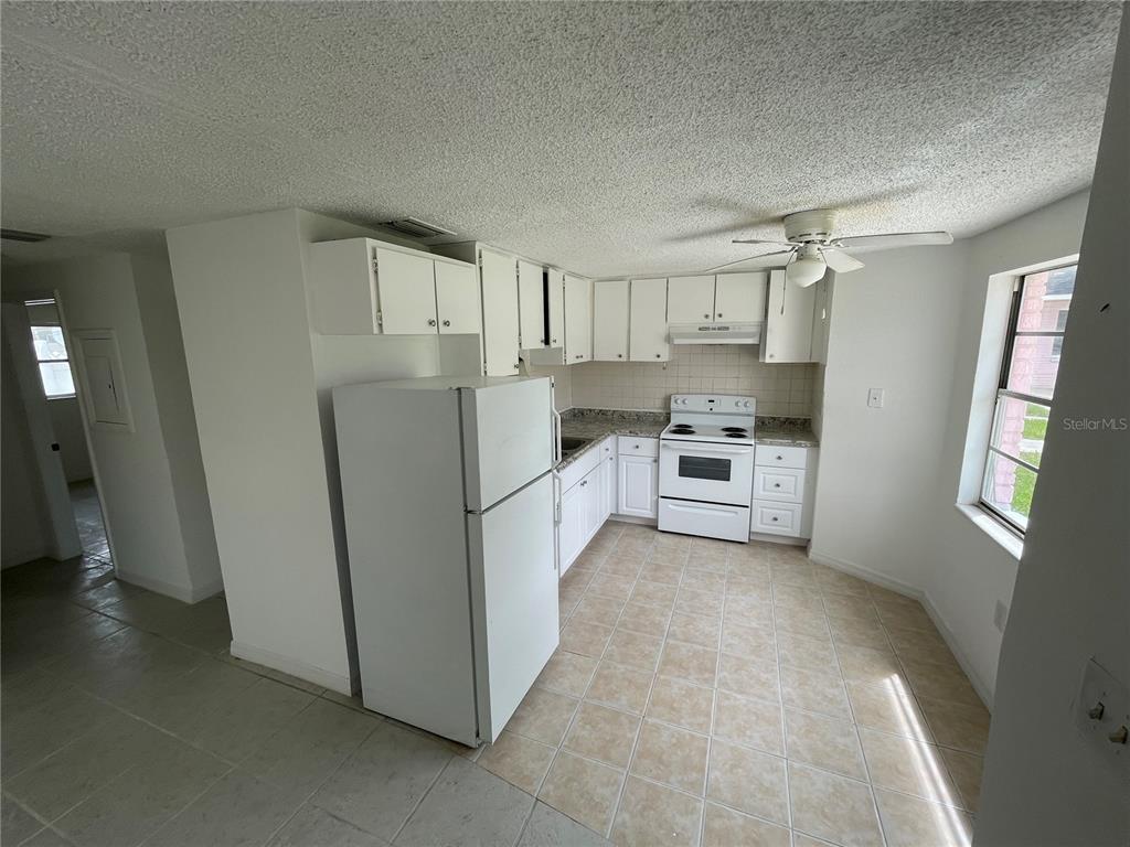 5311 Avery Road New Port Richey, FL 34652 - Photo 17 of 34 a kitchen with white cabinets and white appliances