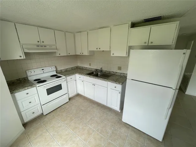a view of a livingroom with a refrigerator