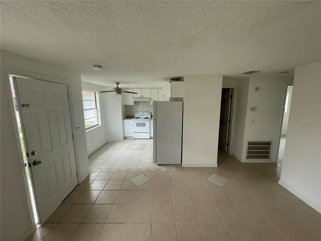 a white refrigerator freezer sitting inside of a kitchen