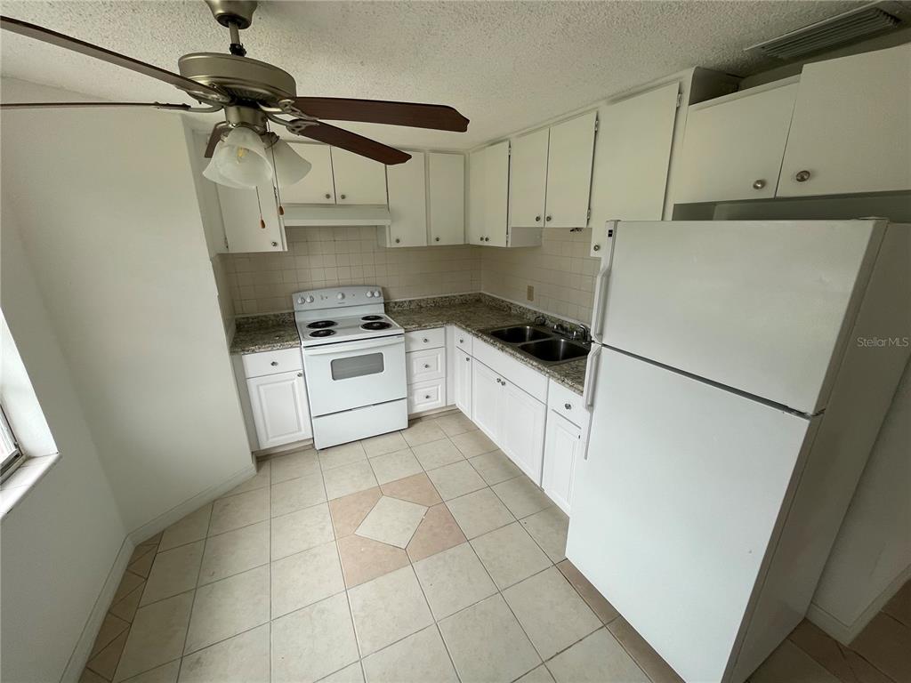 5311 Avery Road New Port Richey, FL 34652 - Photo 5 of 34 a white refrigerator freezer sitting inside of a kitchen