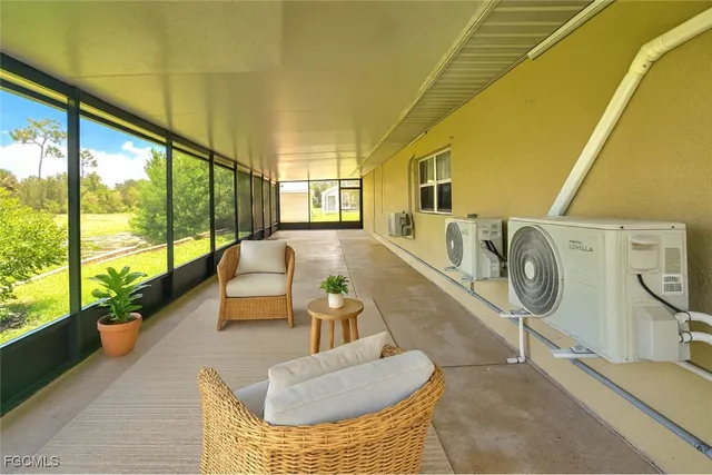 a living room with furniture and a floor to ceiling window