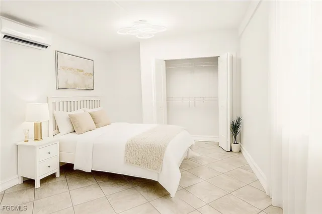 a bedroom with a bed and a painting