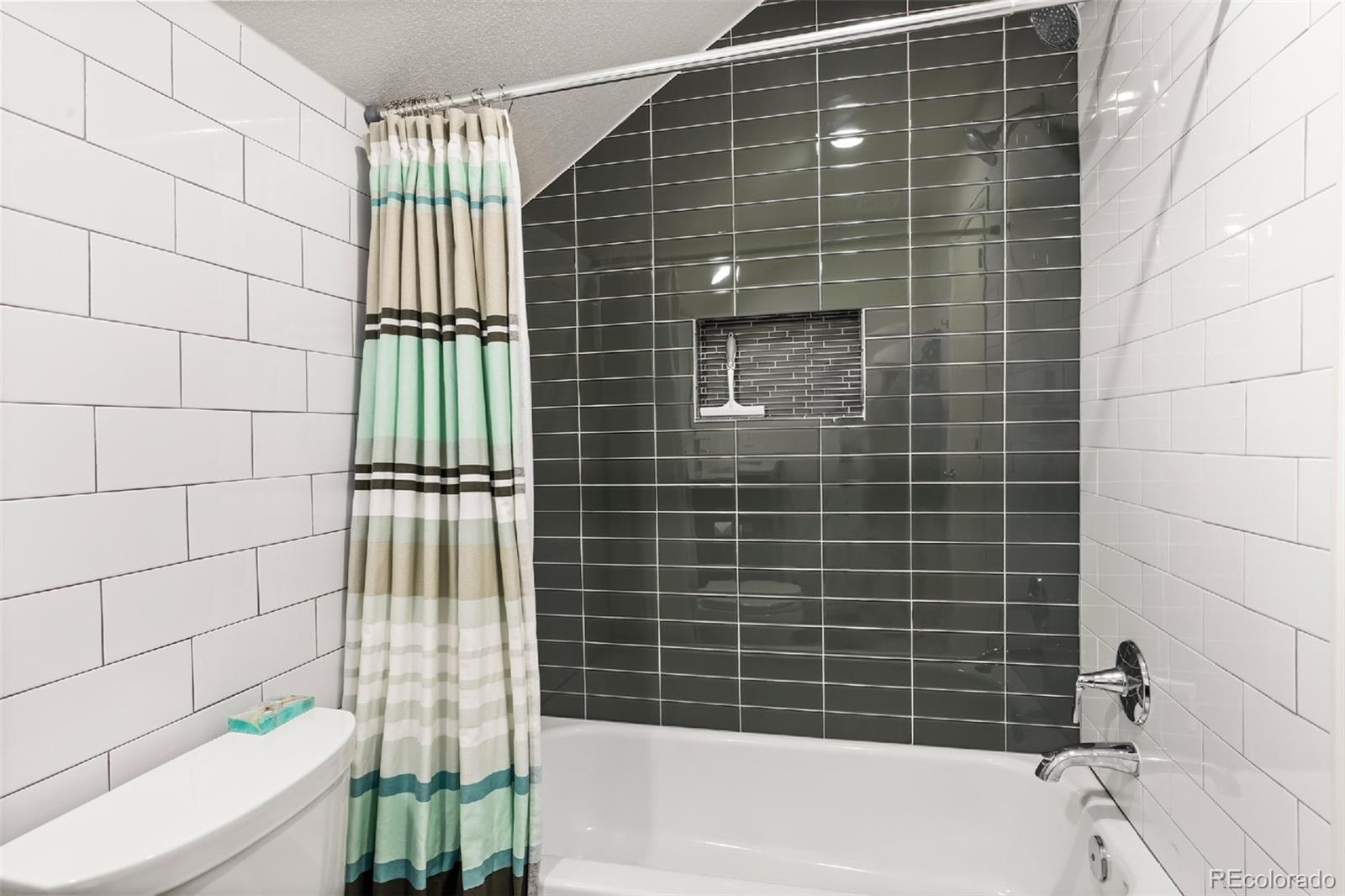 1947 King Street Denver, CO 80204 - Photo 17 of 40 a bathroom with a bathtub and shower