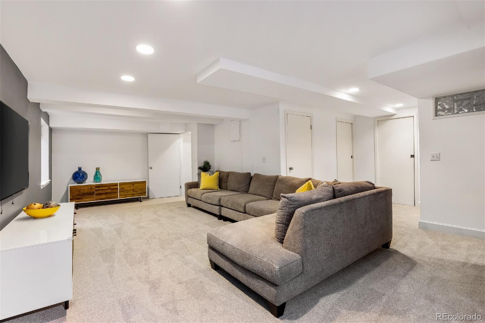 1947 King Street Denver, CO 80204 - Photo 21 of 40 a living room with furniture and a flat screen tv