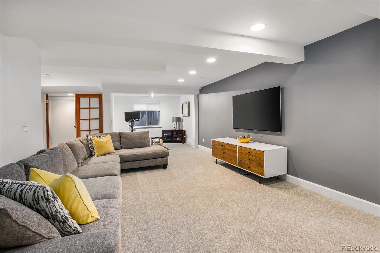 1947 King Street Denver, CO 80204 - Photo 22 of 40 a living room with furniture and a flat screen tv