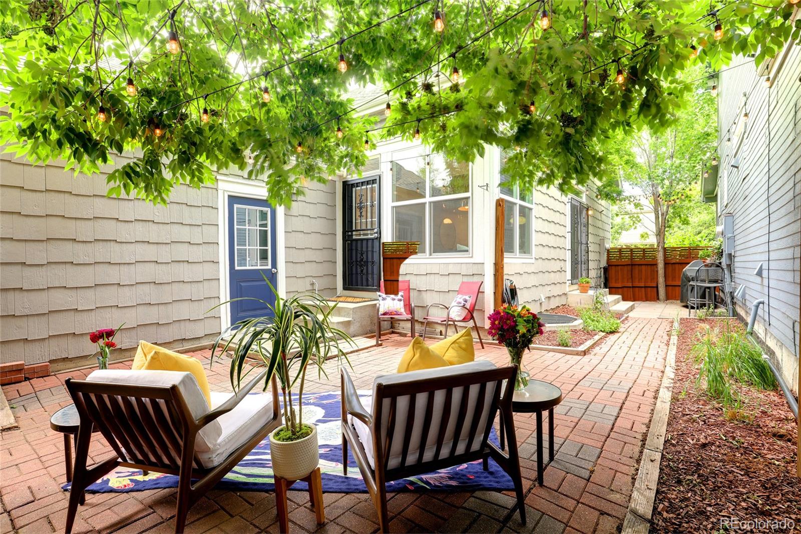 1947 King Street Denver, CO 80204 - Photo 27 of 40 a view of a patio with table and chairs potted plants and a large tree