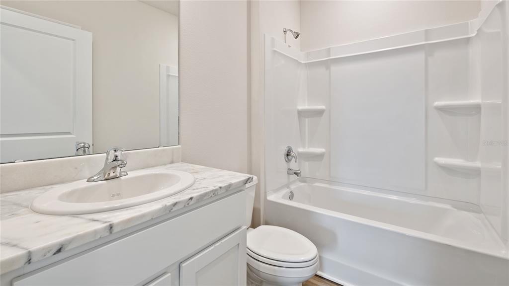 8808 Clear View Street Parrish, FL 34219 - Photo 13 of 16 a bathroom with a sink toilet and a bathtub