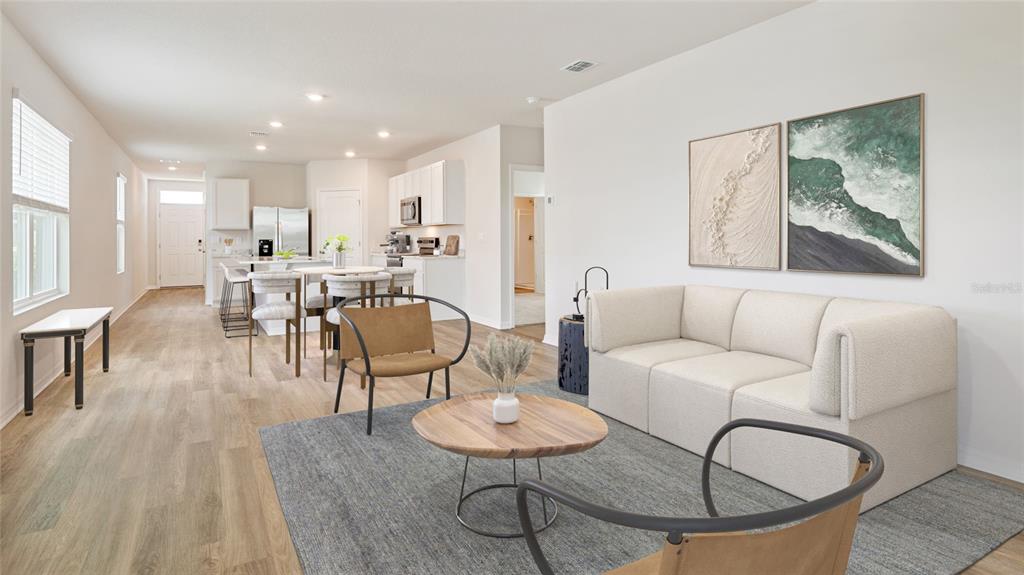 8808 Clear View Street Parrish, FL 34219 - Photo 6 of 16 a living room with furniture and a dining table