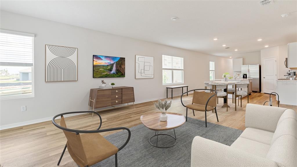8808 Clear View Street Parrish, FL 34219 - Photo 7 of 16 a living room with furniture a flat screen tv and kitchen view