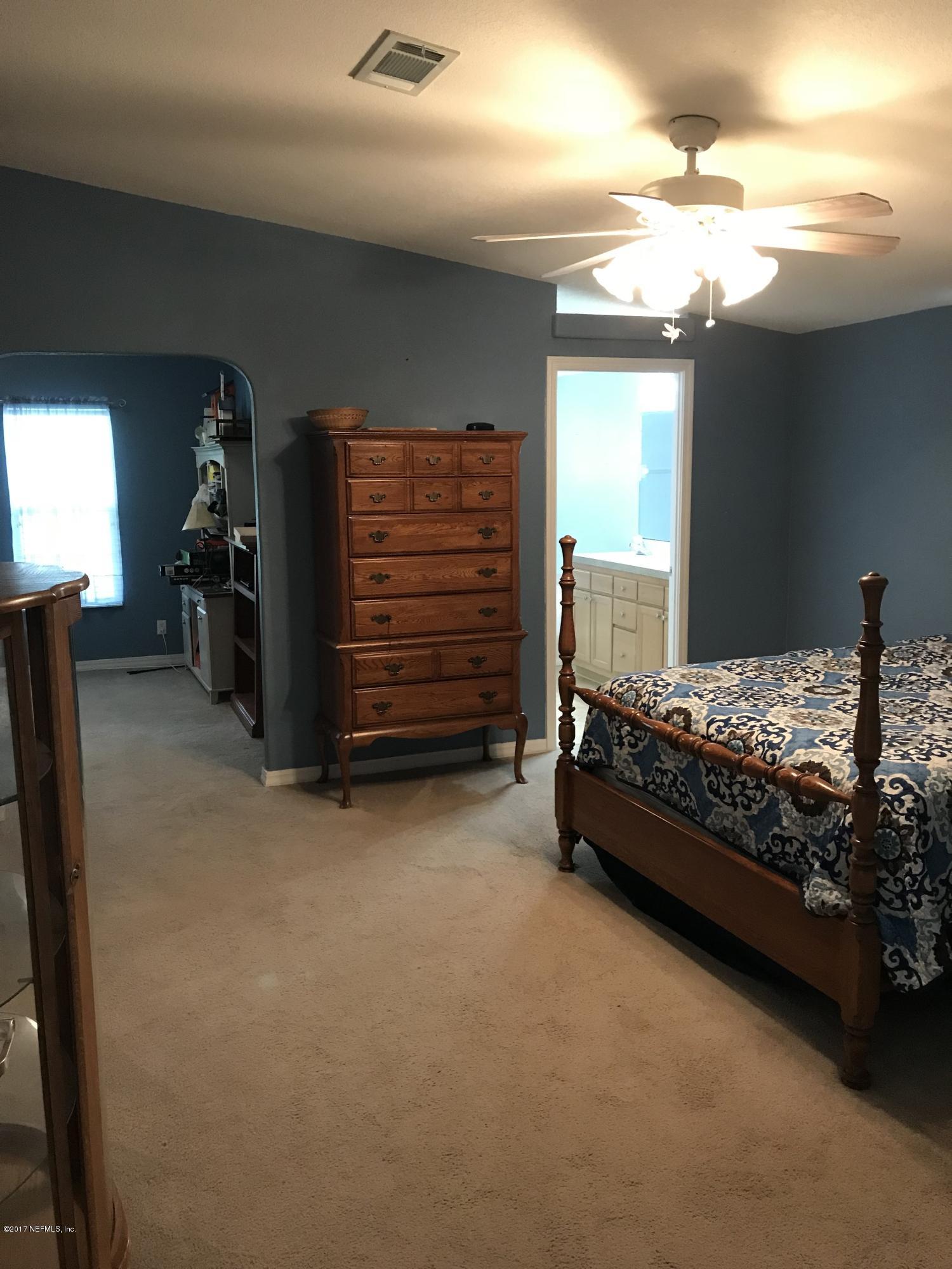 16113 Sawpit Road Jacksonville, FL 32226 - Photo 11 of 18 a bedroom with a bed and a cabinets