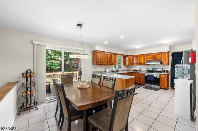 a dining room with furniture and a floor to ceiling window
