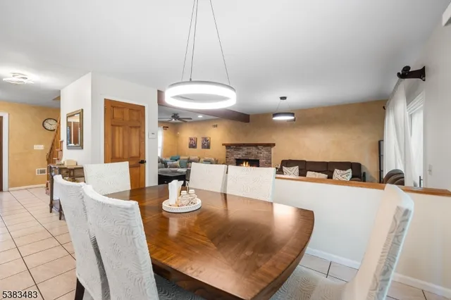 a view of a dining room with furniture and chandelier