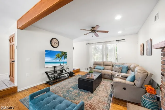 a living room with furniture wooden floor and window