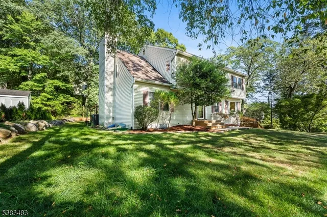 a view of a house with a yard and sitting area