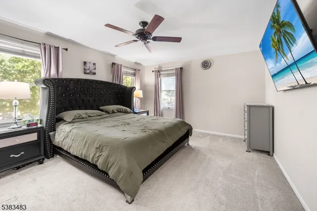 a spacious bedroom with a bed and a large window