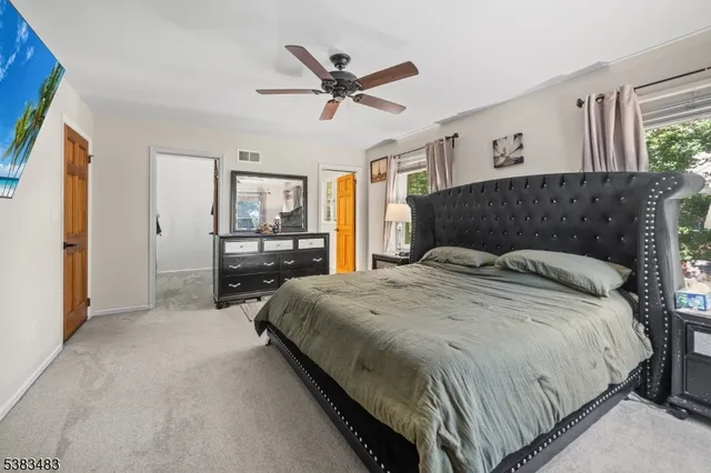 a bedroom with a large bed and a large window