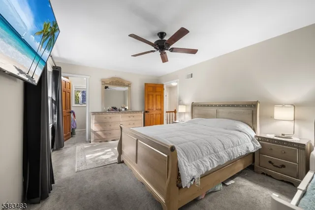 a spacious bedroom with a bed and a chandelier