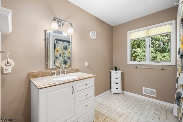 a room with a sink vanity and a mirror