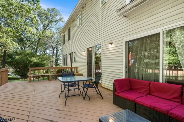 a view of a deck with couches table and chairs and wooden floor