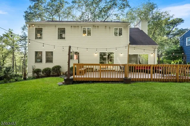 a view of a house with a yard and a porch