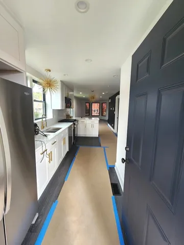 a kitchen with stainless steel appliances a refrigerator a sink a stove a microwave and cabinets