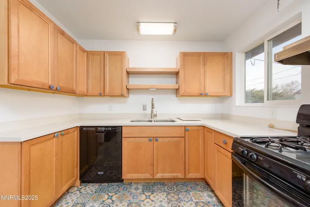 a kitchen with a sink stove and cabinets