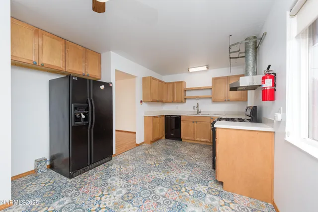 a kitchen with stainless steel appliances granite countertop a refrigerator and a stove