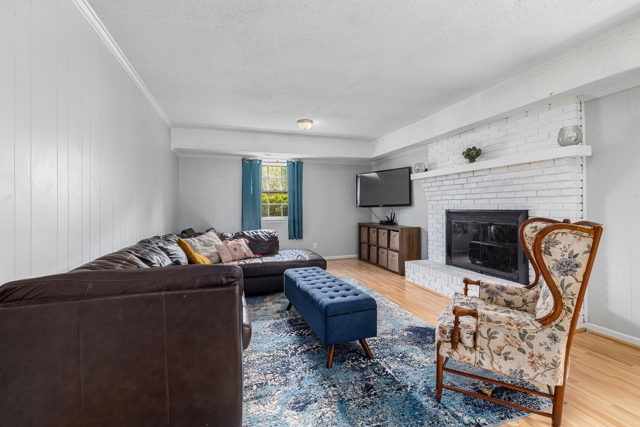 5901 Scalybark Road Durham, NC 27712 - Photo 23 of 49 a living room with furniture a rug a fireplace and a table