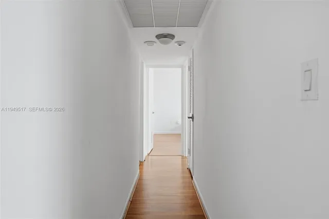 a bedroom with a bed and large windows