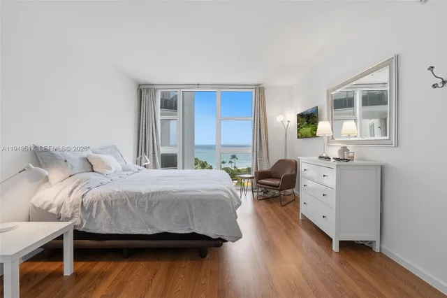 a bedroom with a bed and chair