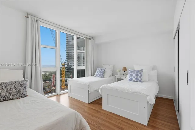 a bedroom with a large bed and a large window