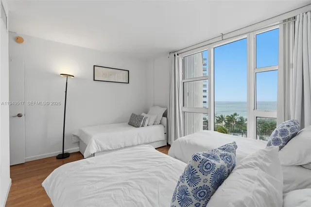 a bedroom with a bed and a night stand